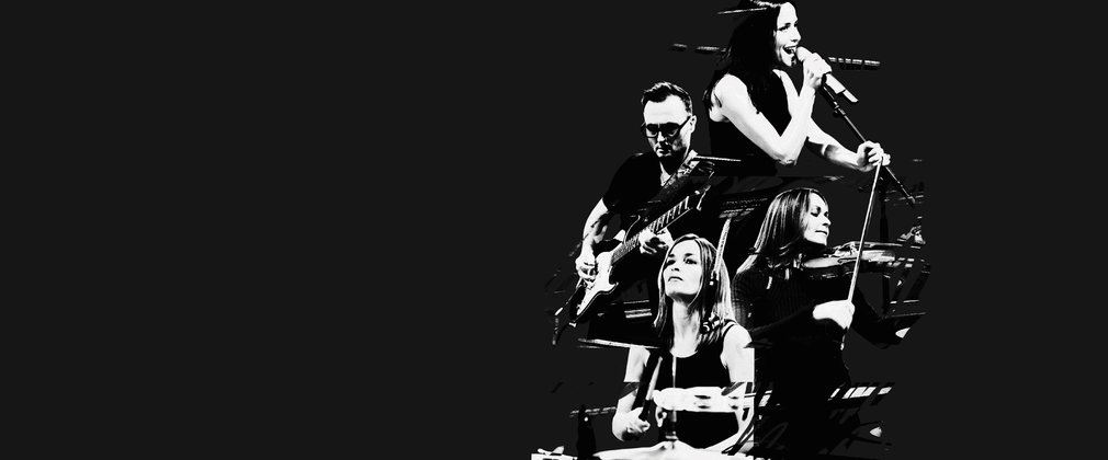 A black and white photo of The Corrs showing them all playing instruments