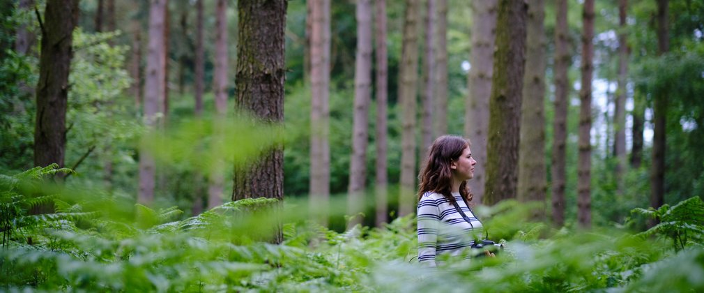 Tiffany Francis stood in waste high forest greenery 