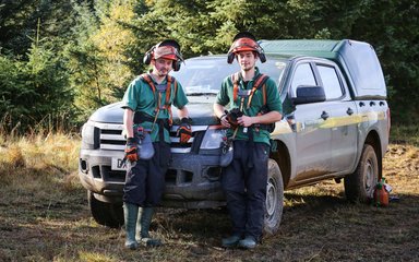 Foresters beside vehicle