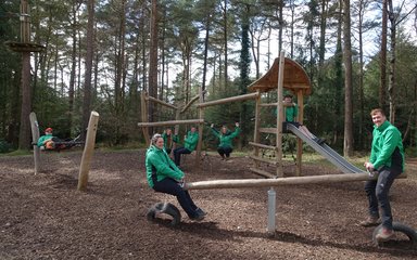 Forestry England rangers on play equipment