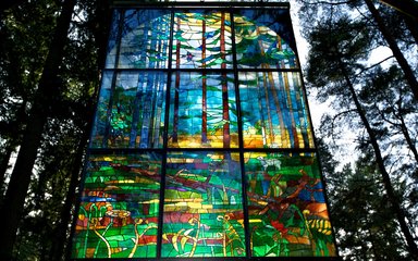 Stained glass pannel hanging in the canopy at beechenhurst sculpture trail