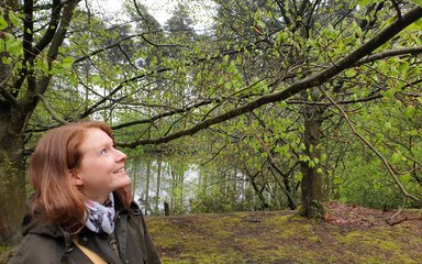 Woman in forest smiling