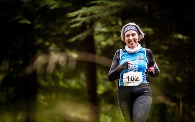 Female trail runner in forest