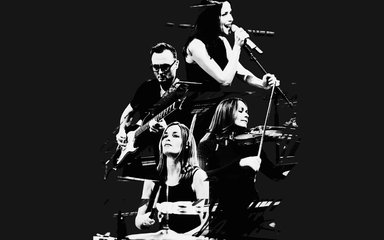 A black and white photo of The Corrs showing them all playing instruments