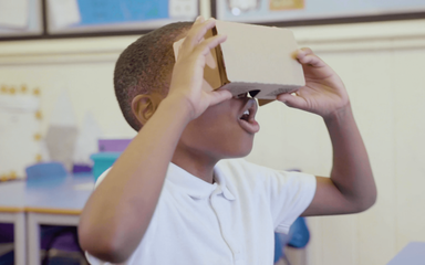 Schoolchild viewing Google Expeditions using a cardboard viewer