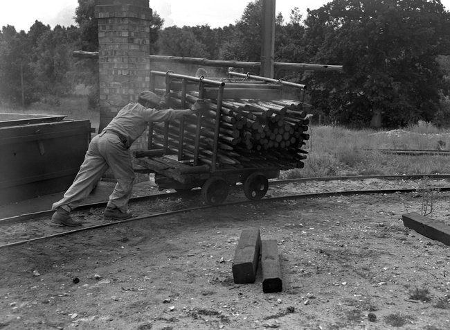 Thetford historic, man pushing logs Thetford historic, man pushing logs