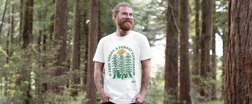 Happy bearded map in white t-shirt in a forest