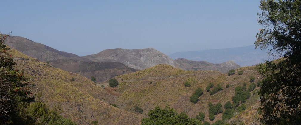 A beautiful landscape of rolling vast hills against a blue sky.