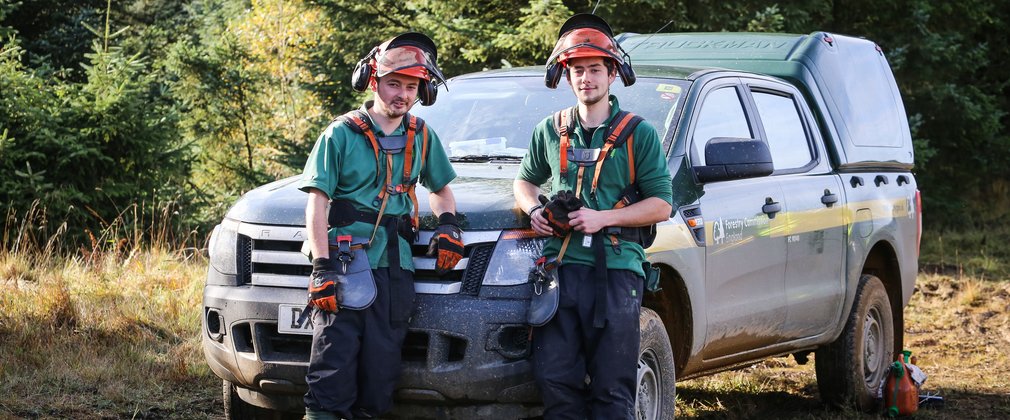 Foresters beside vehicle