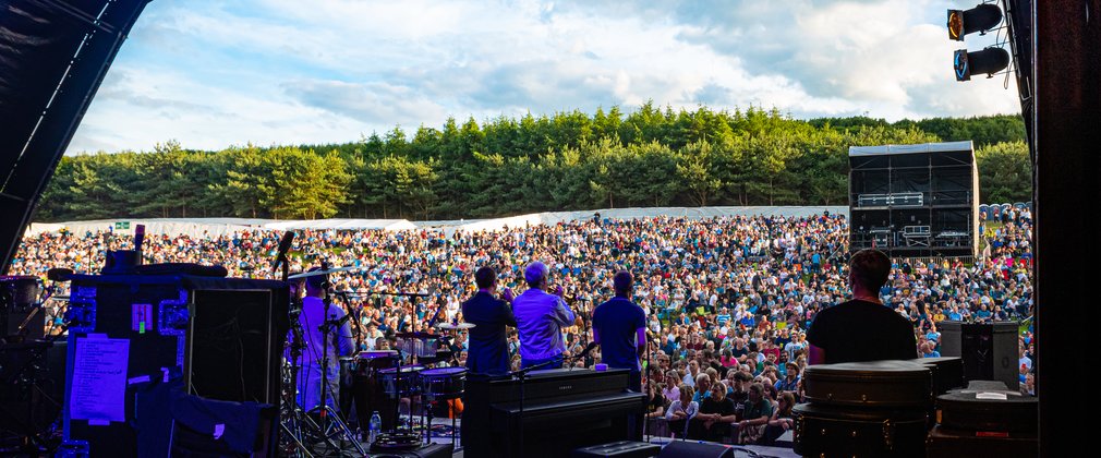Band on the stage looking out at the Forest Live crowd.