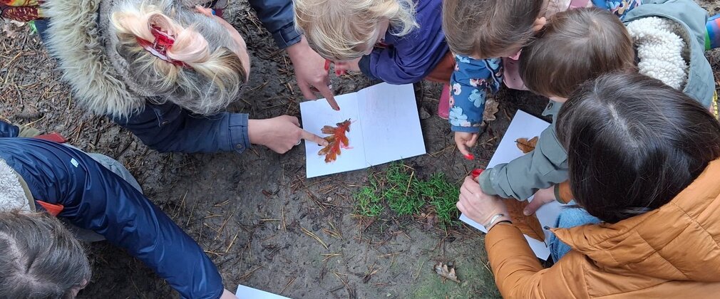 Parents helping children make leaf prints