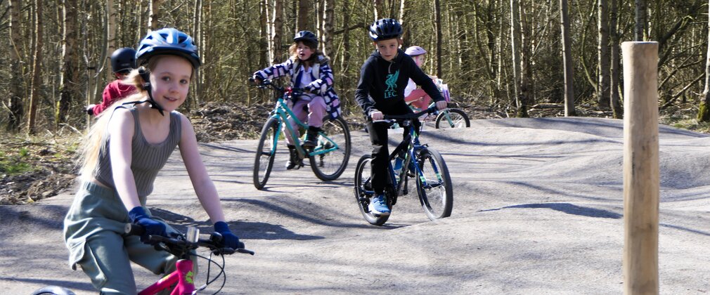 Children riding bikes on Pedal and Play Mountain bike trail