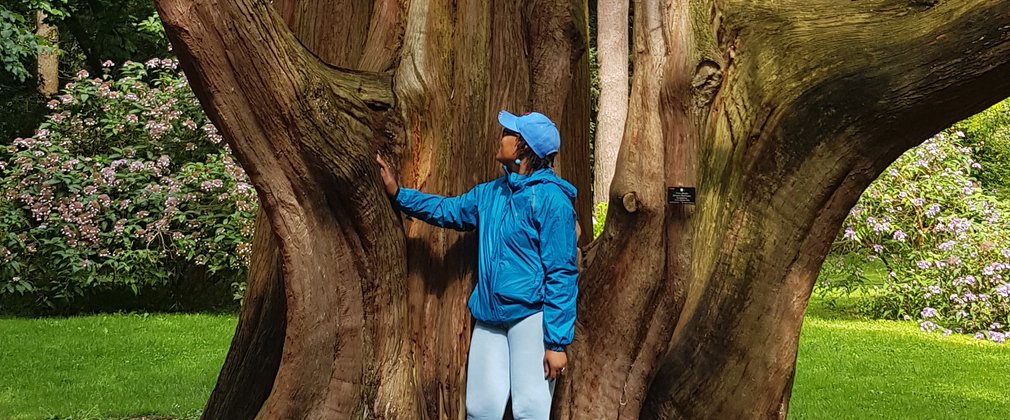 Zakiya Mckenzie stood by large tree