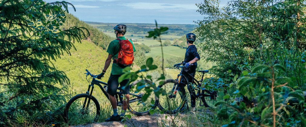 two cyclists admiring the view of an English landscape