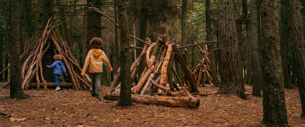 Two children playing in a forest