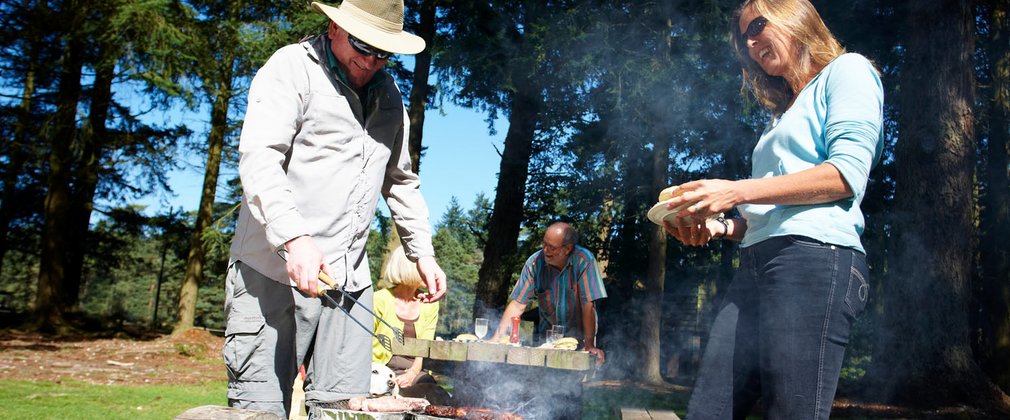 Family enjoying a bbq in the woods