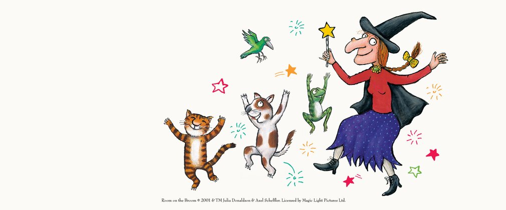 An illustrated witch, cat, dog and frog dancing.