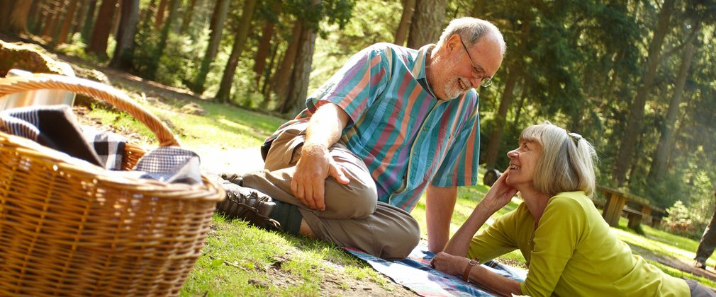 couple enjoying a picnic in a clearing within a forest