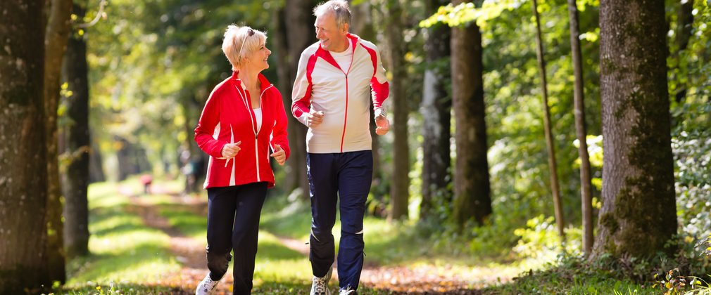 couple running through the forest 