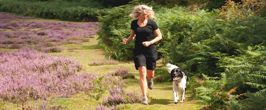 Woman running with dog