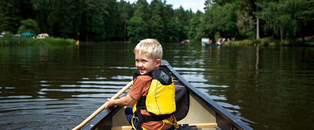 boy enjoying kayaking on the river