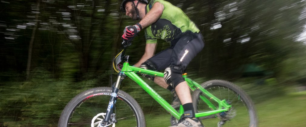 Mountain biker cycling through the forest 