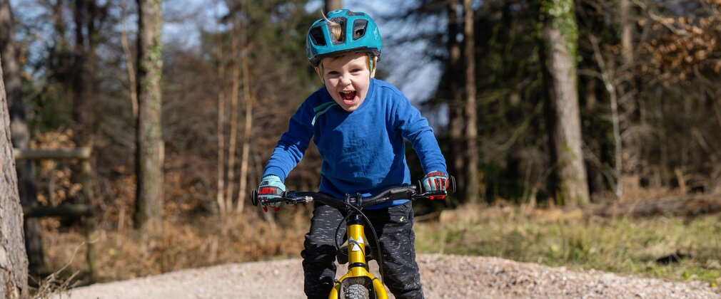 Child riding a mountain bike on a pump track