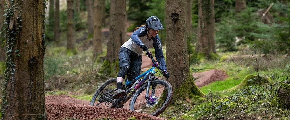 Female rider on mountain bike trail in the Forest of Dean