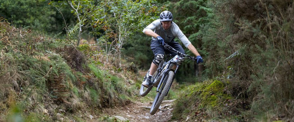 Mountain biker riding a technical trail section