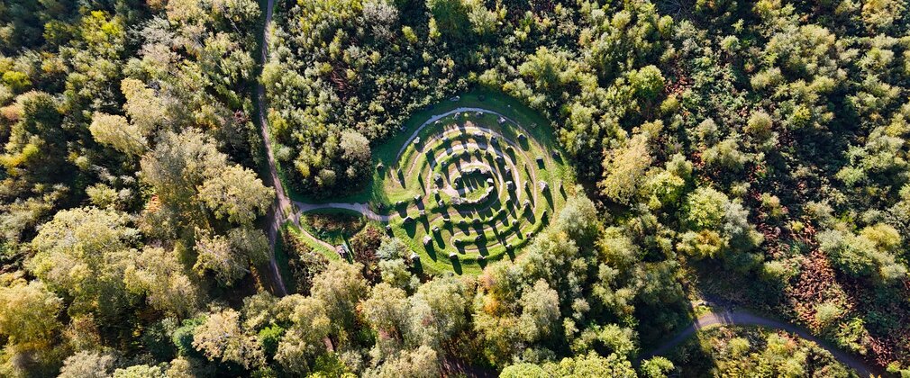 A drone shot looking down on a natural tree labyrinth