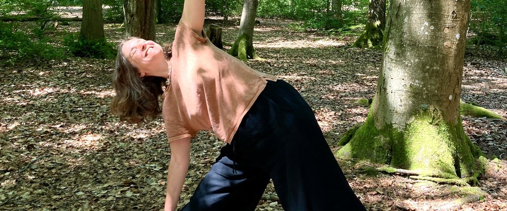 A person practising yoga in the forest