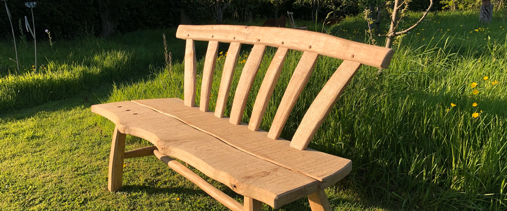 An oak bench made by hand at Westonbirt Arboretum.