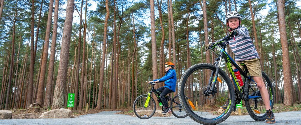Two children ready to race on the Pedal and Play bike trail