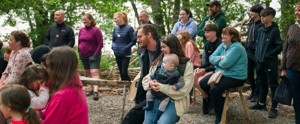 gathering of people in woodland at Festival of Archaeology