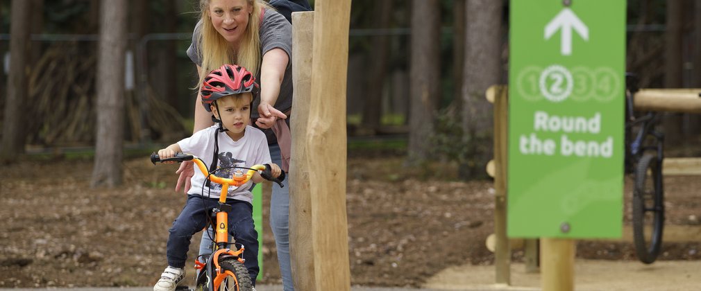 Child navigating obstacles on a bike 