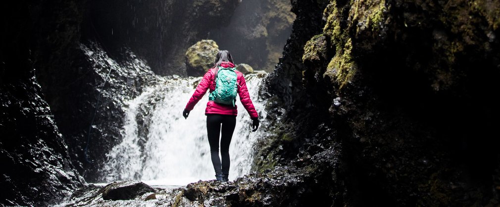 Lady exploring a waterfall