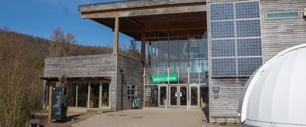 A Visitor Centre building made out of wood with a large glass frontage.
