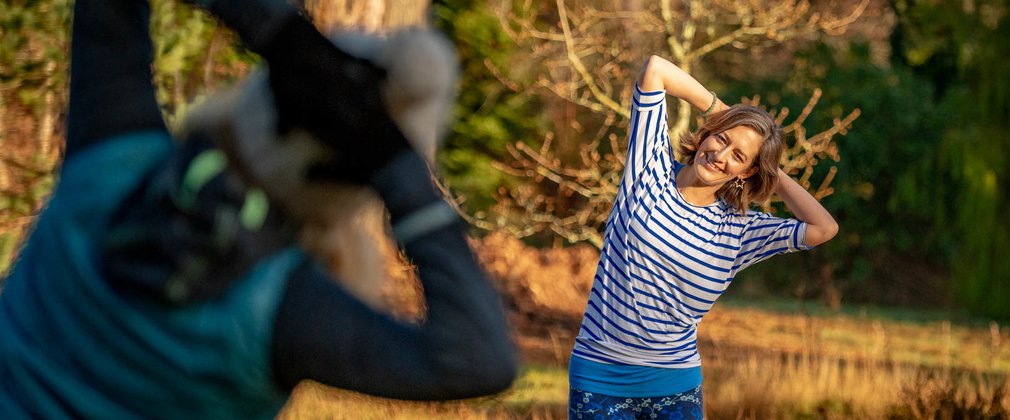 Two people doing Pilates in the forest