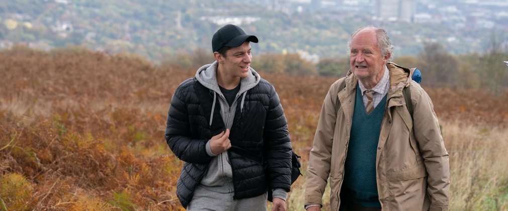 Two men walking on a country road