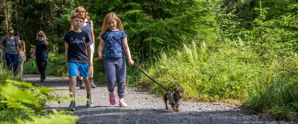 family walking with dog