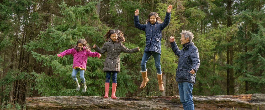 Bedgebury National Pinetum and Forest - family jumping off a log