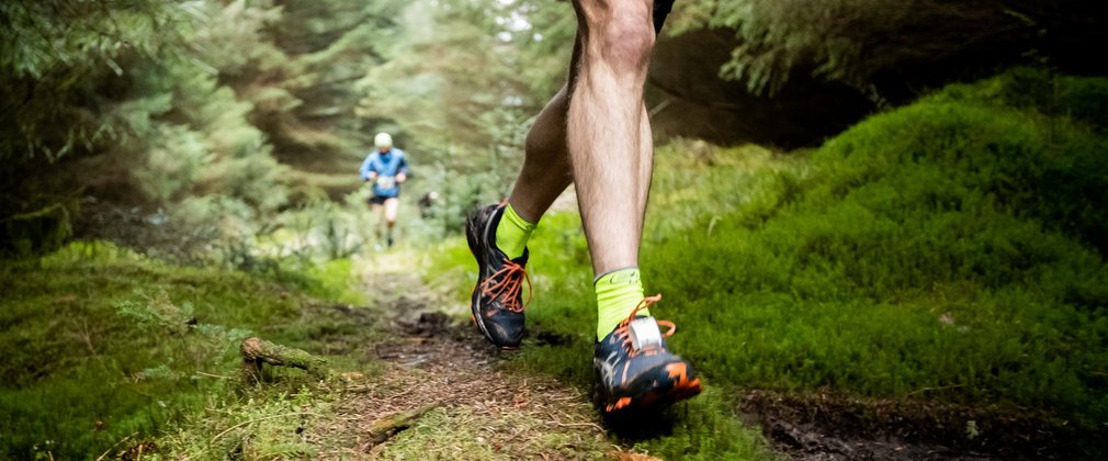 man running in forest trail