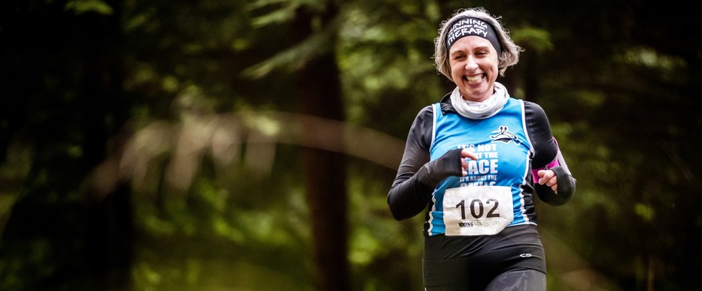 Female trail runner in forest