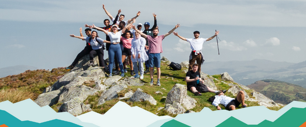 A group of people celebrating on a mountain top