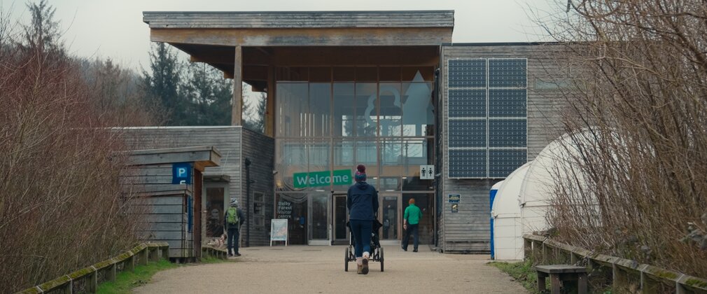 A member walking towards Dalby Forest Visitor Centre
