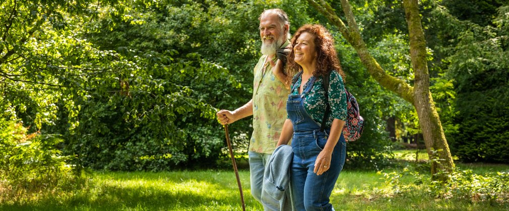 Couple walking on bright green grass looking content