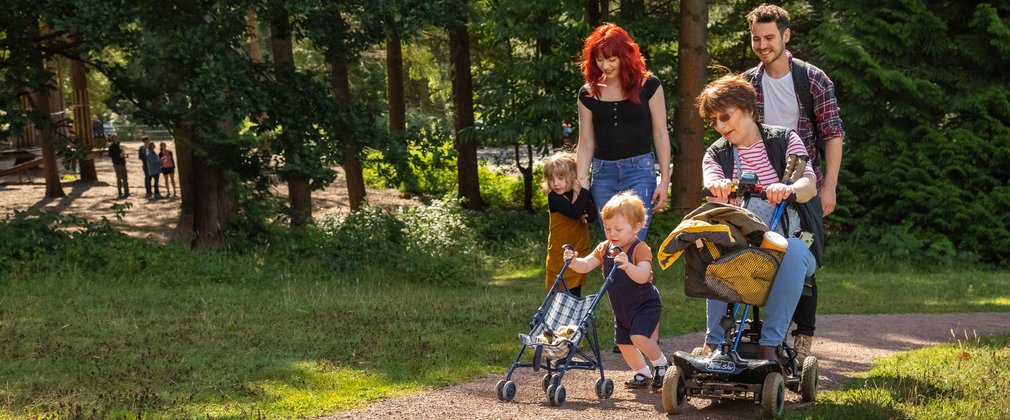 Family laughing together on an easy access trail