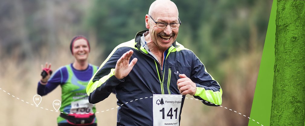 Smiling man, running through woodland