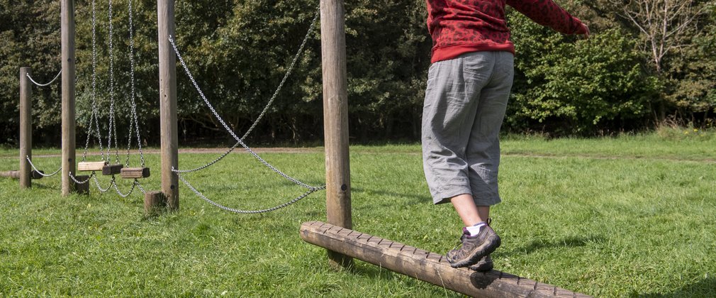 Balancing on a wooden beam