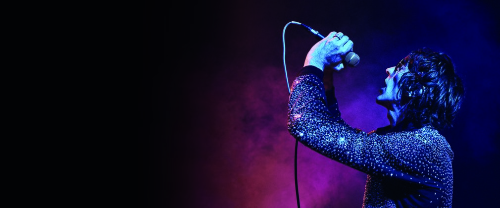 Singer Richard Ashcroft sings into a microphone 